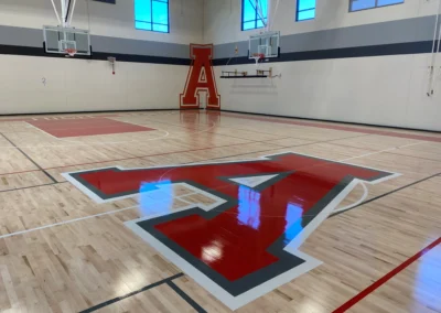 gymnasium maple floors with red A graphics