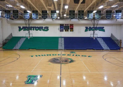 Multicolor telescoping bleachers in a high school gymnasium