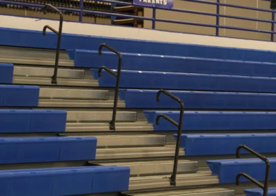 BROC blue telescoping bleachers in a US High School gymnasium