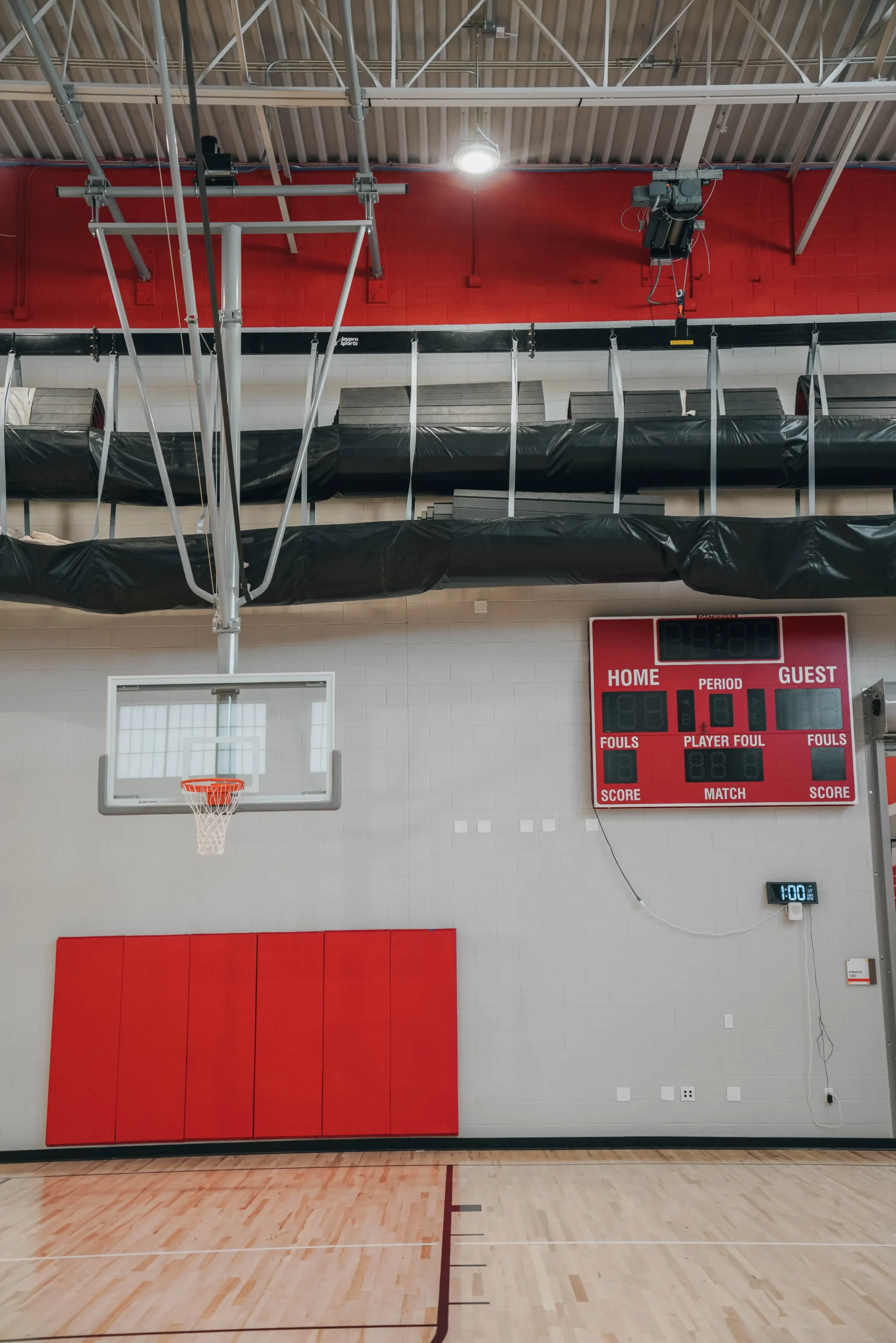 K-12 school gymnasium sport equipment. retractable basketball hoop, wall pad, wrestling mat hoist and scoreboard